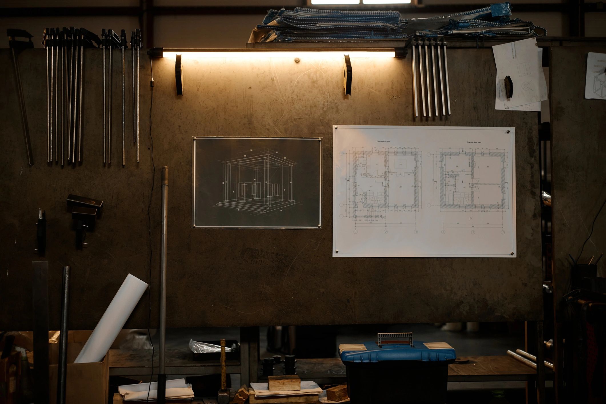 Blueprints and tools in a metal fabrication workshop